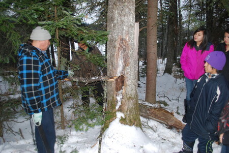 Elder/Cultural Advisor Herman Sutherland educates students about setting traps at Kee Tas Kee Now Tribal Council (KTC) – NSD61 Winter Camp in February 2015.